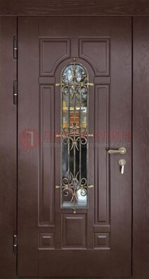 Темная железная дверь со стеклом и ковкой для частного дома ДСК-156 в Кингисеппе